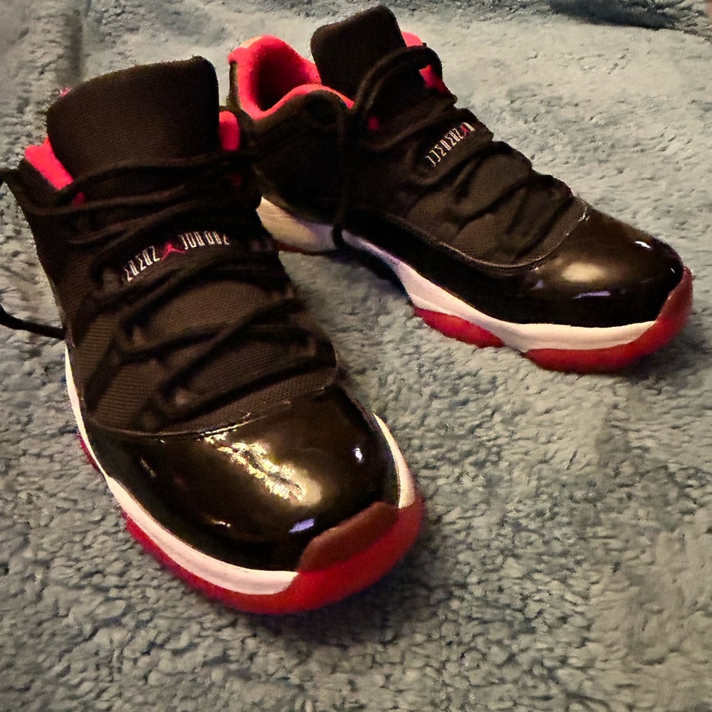 Air Jordan basketball shoe. Low. Black patent  with red and white trim.